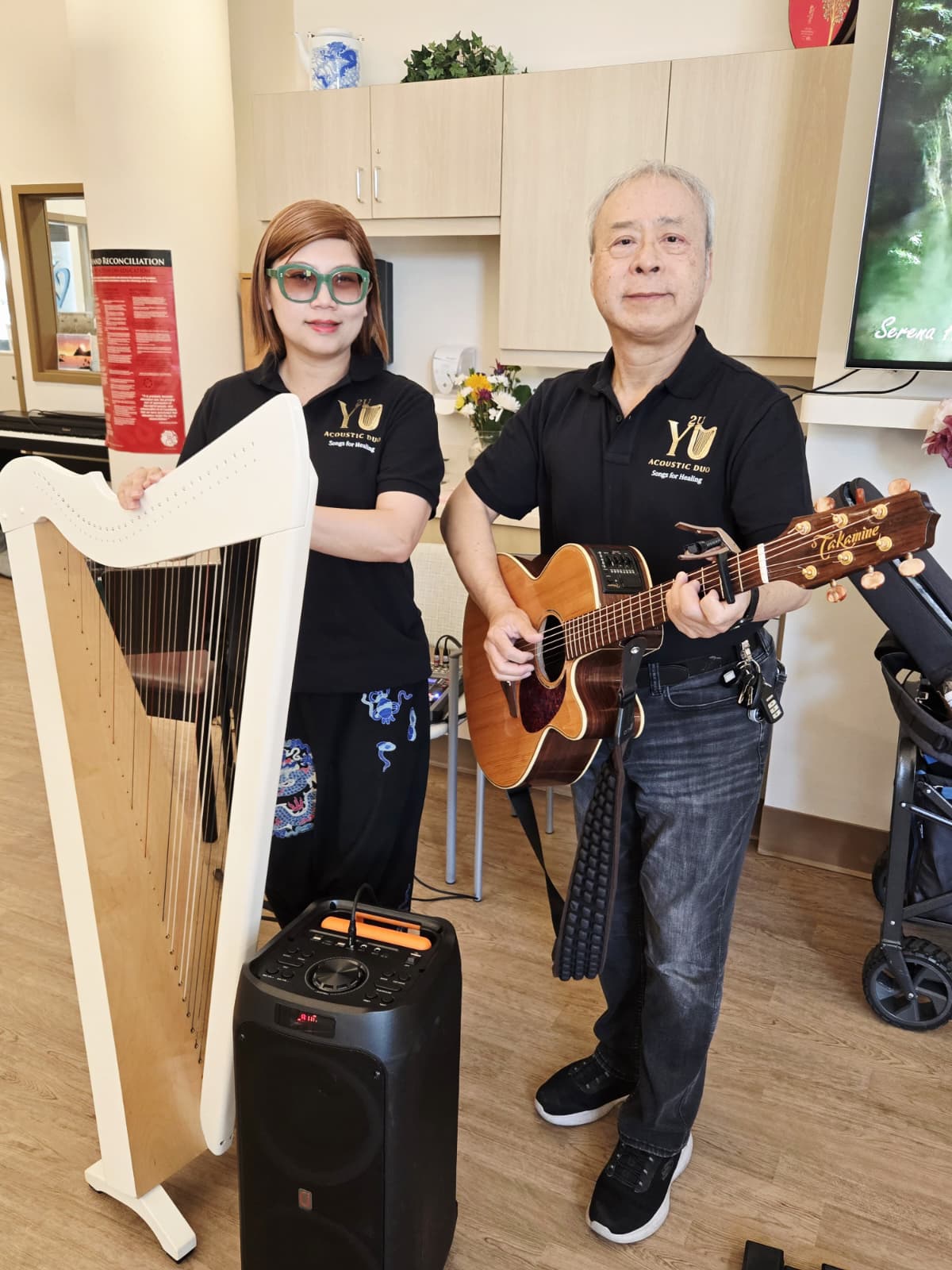 Gloria and Mackenzie performing a harp and guitar duet